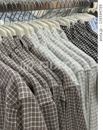 Plaid shirts on hangers in a retail store clothing rack display Plaid shirts on hangers in a retail store clothing rack display 138594789
