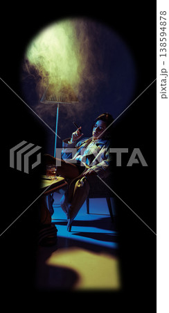 Confident woman smoking cigar in armchair with dramatic lighting seen through keyhole. Confident woman smoking cigar in armchair with dramatic lighting seen through keyhole. 138594878