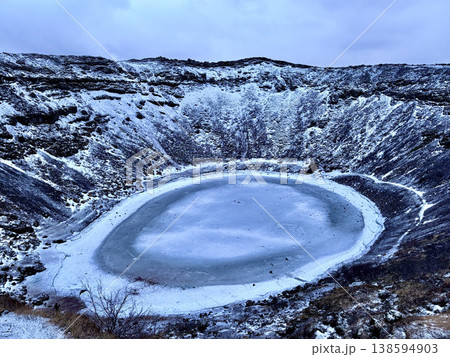 Wide angle view of Kerid volcanic crater with frozen lake in Iceland, winter. Wide angle view of Kerid volcanic crater with frozen lake in Iceland, winter. 138594903