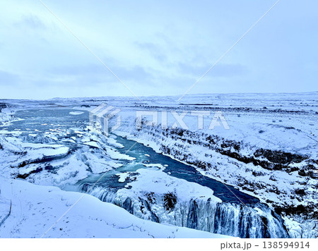 Wide panoramic view of the frozen Gullfoss waterfall and canyon in winter, Iceland. Wide panoramic view of the frozen Gullfoss waterfall and canyon in winter, Iceland. 138594914