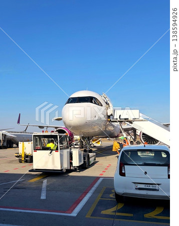 Ground handling of a commercial airplane at the airport apron before flight. Ground handling of a commercial airplane at the airport apron before flight. 138594926