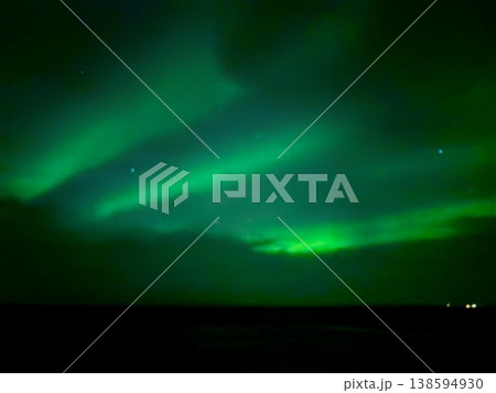 Stunning Aurora Borealis glowing through night clouds in the sky of Iceland. Stunning Aurora Borealis glowing through night clouds in the sky of Iceland. 138594930