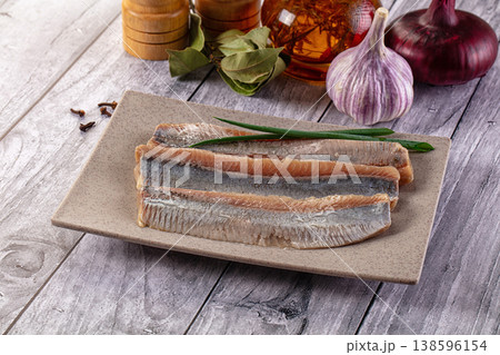 Marinated salted herring fillet slices 138596154