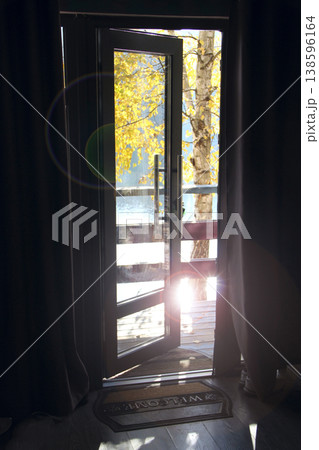 An open door leading to the lake in autumn. Room design. Room ventilation An open door leading to the lake in autumn. Room design. Room ventilation 138596164