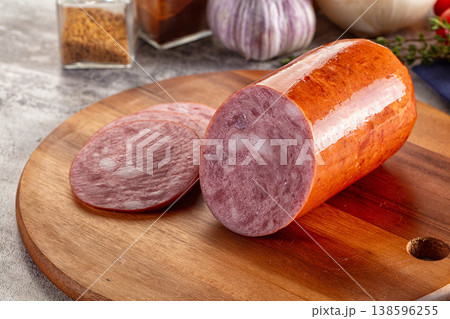 Ham sausage with slice over board Ham sausage with slice over board 138596255