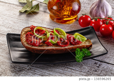 Baked eggplant with tomato and leek 138596265
