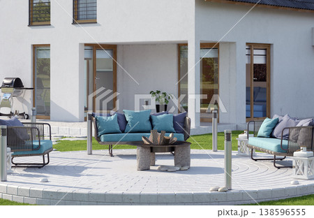 Modern backyard patio with teal outdoor furniture and fire pit. 3D render of home exterior Modern backyard patio with teal outdoor furniture and fire pit. 3D render of home exterior 138596555