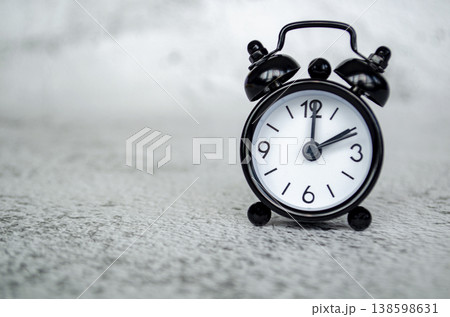 Minimal alarm clock thumbnail depicting a two o clock afternoon time reference with a calm monochrome tabletop presentation 138598631