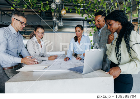 Black project manager pitching concept to white and asian clients Black project manager pitching concept to white and asian clients 138598704