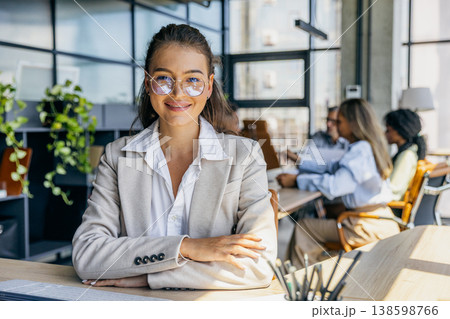 Caucasian marketing chief shows warm smile with arms crossed Caucasian marketing chief shows warm smile with arms crossed 138598766