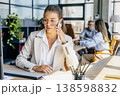 Customer success specialist on call and reviewing files 138598832