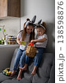 Two sisters with bunny ears holding Easter basket at home 138598876