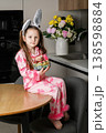 Little girl in bunny ears holding Easter eggs basket at home 138598884