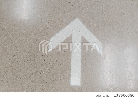 Arrow Sign on a Polished Floor Indicating Direction for Guidance and Navigation in a Modern Environment 138600680
