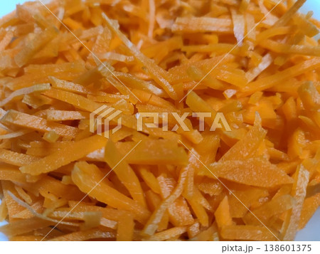 Close-up of Freshly Shredded Carrots on White Plate Highlighting Bright Orange Color and Texture for Healthy Cooking and Nutrition Photography Close-up of Freshly Shredded Carrots on White Plate Highlighting Bright Orange Color and Texture for Healthy Cooking and Nutrition Photography 138601375