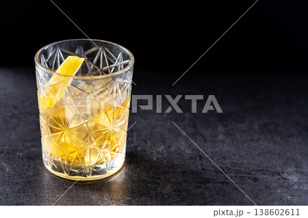 Rusty Nail Cocktail with Lemon Peel in Crystal Glass Rusty Nail Cocktail with Lemon Peel in Crystal Glass 138602611