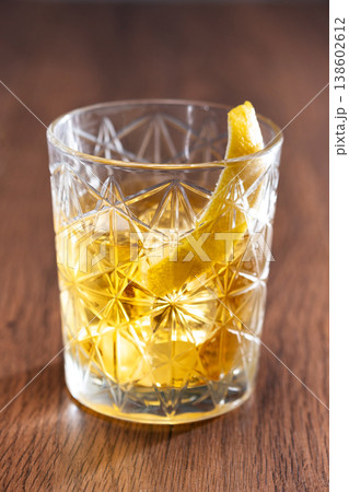 Rusty Nail Cocktail with Lemon Peel in Crystal Glass Rusty Nail Cocktail with Lemon Peel in Crystal Glass 138602612