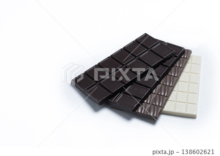 Assortment of white, milk and dark chocolate pieces isolated on white background Assortment of white, milk and dark chocolate pieces isolated on white background 138602621