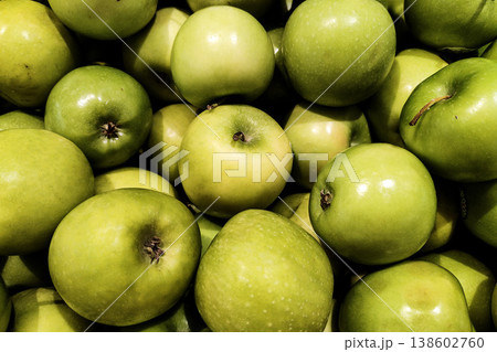 Fresh and Vibrant Green Apples Piled Together in a Market Display, Showcasing Their Juicy Texture and Natural Colorfulness Fresh and Vibrant Green Apples Piled Together in a Market Display, Showcasing Their Juicy Texture and Natural Colorfulness 138602760