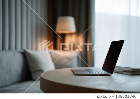 Laptop on round table in cozy minimalist living room Laptop on round table in cozy minimalist living room 138602840