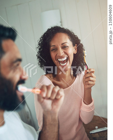 Cleaning, teeth and couple in bathroom with dental, healthcare and wellness in home. Happy, smile and people washing mouth with toothbrush, toothpaste and healthy brushing together in morning routine Cleaning, teeth and couple in bathroom with dental, healthcare and wellness in home. Happy, smile and people washing mouth with toothbrush, toothpaste and healthy brushing together in morning routine 138604609