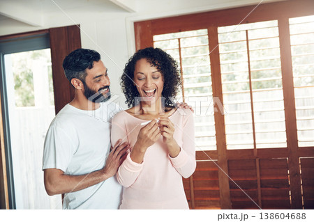 Couple, excited and positive pregnancy test at home, hug and happy for future, support and love. Smiling people, success and pregnant by ivf, fertility and good news, results and celebration for baby Couple, excited and positive pregnancy test at home, hug and happy for future, support and love. Smiling people, success and pregnant by ivf, fertility and good news, results and celebration for baby 138604688
