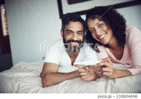 Couple, happy and portrait with pregnancy test, bedroom and positive with smiling, results and excited. Man, woman and baby with stick, love and maternity for future family, surprise and pregnant 138604696