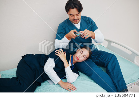 Doctors, friends and sleeping in picture for social median phone in clinic, joke and silly or goofy. Medical professionals, fun and comedy on break, tired and fatigue from work, hospital bed and rest Doctors, friends and sleeping in picture for social median phone in clinic, joke and silly or goofy. Medical professionals, fun and comedy on break, tired and fatigue from work, hospital bed and rest 138604771