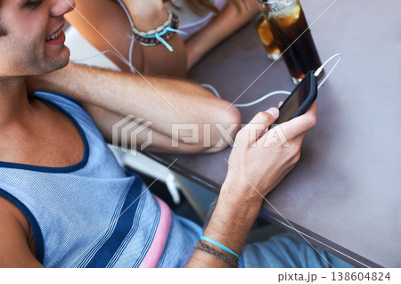 Smile, cafe and a man with a phone for music, listening to a podcast or watching a video. Happy, social media and a person with a mobile for a radio app, sound or streaming audio at a restaurant 138604824