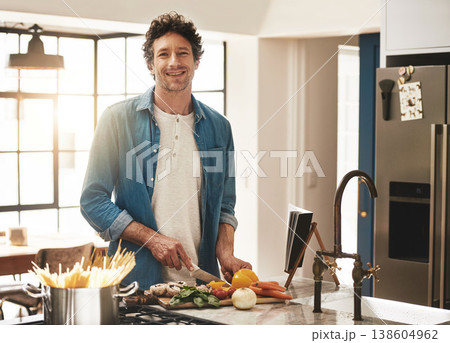 Happy, portrait and man cutting vegetables in the kitchen for diet, healthy or nutrition dinner. Smile, cooking and mature male person from Canada chop ingredients for a supper or lunch meal at home. Happy, portrait and man cutting vegetables in the kitchen for diet, healthy or nutrition dinner. Smile, cooking and mature male person from Canada chop ingredients for a supper or lunch meal at home. 138604962