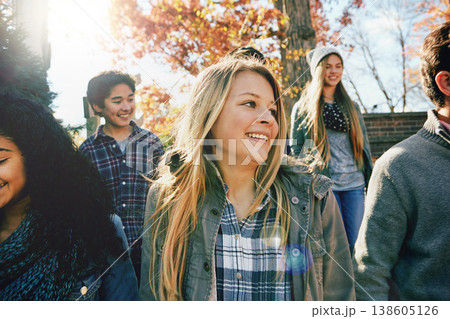 Walking, teenager and talking with friends in park, nature or social group outdoor together with diversity. Happy, teens or kids relax in fall with a joke, best friend or conversation in community Walking, teenager and talking with friends in park, nature or social group outdoor together with diversity. Happy, teens or kids relax in fall with a joke, best friend or conversation in community 138605126