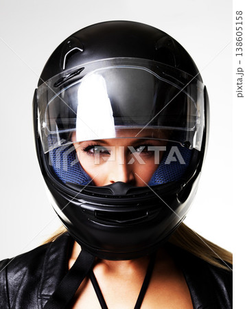 Motorbike helmet, portrait and sexy woman in studio isolated on white background. Biker, face and safety of serious girl, sports protection and fashion style, motorcyclist racer and beauty of driver Motorbike helmet, portrait and sexy woman in studio isolated on white background. Biker, face and safety of serious girl, sports protection and fashion style, motorcyclist racer and beauty of driver 138605158