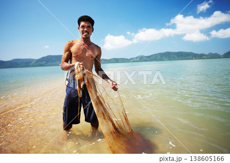 Fisherman, ocean and man with net working, nature and labor with fishing in Thailand and tropical island. Sea, job and rope with worker in water to catch fish and beach with environment and portrait Fisherman, ocean and man with net working, nature and labor with fishing in Thailand and tropical island. Sea, job and rope with worker in water to catch fish and beach with environment and portrait 138605166