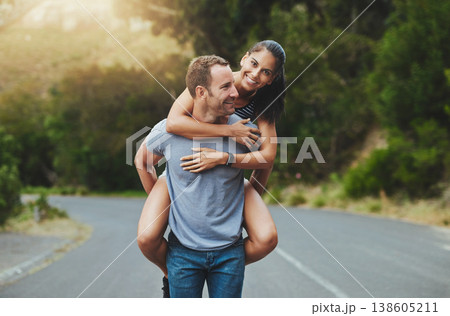 Piggyback, love or happy couple walking on road or date with smile for romance, summer or adventure. Portrait, trust or man with woman on holiday vacation for bond, support or wellness on street 138605211