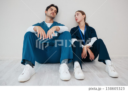 Nurses, serious couple and relax in hospital, talking and communication. Medical workers, man and woman on break, conversation and healthcare team bonding, support and connection for love in clinic 138605323