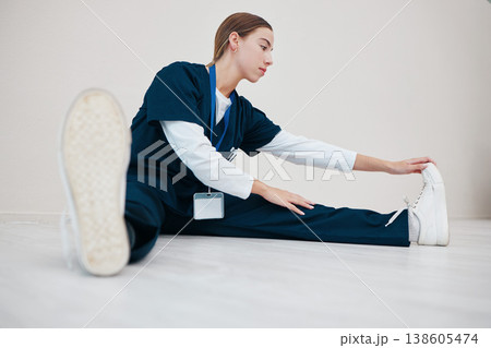 Hospital, medical and a nurse stretching on the floor of a studio, getting ready for healthcare or treatment. Legs, warm up and a confident young volunteer or medicine professional on mock up 138605474