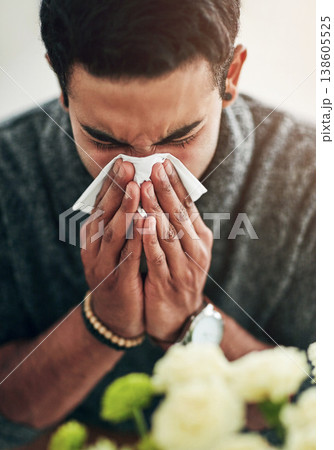 Face, hand and blowing nose with a man using a tissue in his home for relief from allergy symptoms. Sick, cold or flu disease and a young person ill with a virus due to bacteria, pollen or hay fever Face, hand and blowing nose with a man using a tissue in his home for relief from allergy symptoms. Sick, cold or flu disease and a young person ill with a virus due to bacteria, pollen or hay fever 138605525