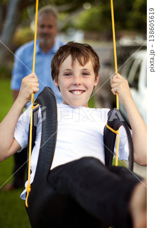 Portrait, boy and swing at park with father for fun, childhood freedom and energy together. Happy young kid swinging with dad in garden, playground and outdoor for bonding, break and enjoy playing Portrait, boy and swing at park with father for fun, childhood freedom and energy together. Happy young kid swinging with dad in garden, playground and outdoor for bonding, break and enjoy playing 138605619