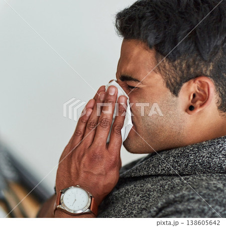Profile, hand and blowing nose with a man using a tissue closeup in his home for relief from allergy symptoms. Face, sick with a cold or flu and a young person sneezing due to a virus or hay fever 138605642