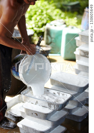 Rubber, farming and person with container in workshop, factory and production warehouse. Plantation, agriculture and worker with bucket for labour, plastic and material manufacturing in Thailand 138605649