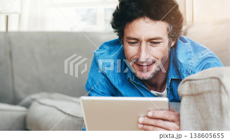 Man, relax and tablet internet on couch for digital contact, social media or movie app. Male person, streaming film and online shop connection or connectivity fun for comfort, weekend joy on sofa Man, relax and tablet internet on couch for digital contact, social media or movie app. Male person, streaming film and online shop connection or connectivity fun for comfort, weekend joy on sofa 138605655