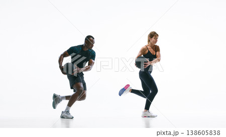 Athletic couple performing medicine ball rotation exercise for core strength training Athletic couple performing medicine ball rotation exercise for core strength training 138605838