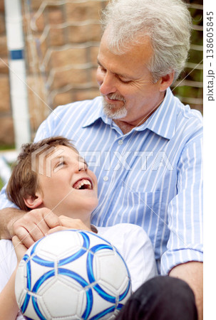 Senior, man or boy with smile and ball for football, sport or bonding in backyard, garden or field. Family, elderly person or son with happiness for soccer match, game or performance at home for care 138605845