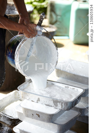 Rubber, agriculture and person with container in workshop, factory and production warehouse. Plantation, farming and worker with bucket for latex, plastic and material manufacturing in Thailand 138605934