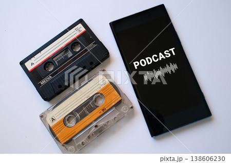 Vintage audio casettes and mobile phone with podcast app on screen 138606230