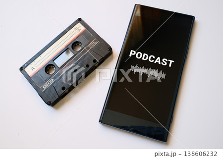 Vintage audio casette and mobile phone with podcast app on screen 138606232
