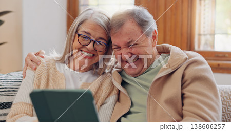 Tablet, social media and a senior couple laughing in the living room of their home together during retirement. Technology, love and relax with funny elderly people looking at a meme on the sofa Tablet, social media and a senior couple laughing in the living room of their home together during retirement. Technology, love and relax with funny elderly people looking at a meme on the sofa 138606257