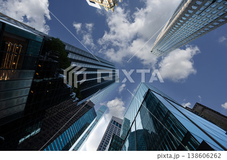 New york, usa august 14,2024. Modern manhattan buildings and office towers reaching up toward the bright blue sky with white clouds, showing architecture and urban growth New york, usa august 14,2024. Modern manhattan buildings and office towers reaching up toward the bright blue sky with white clouds, showing architecture and urban growth 138606262