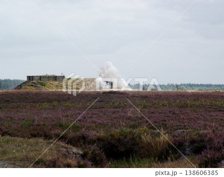 War, explosion and missile attack in the countryside during conflict or fighting for freedom with space. Sky, mockup and bomb with a cloud of smoke outdoor on a military warzone or battlefield 138606385