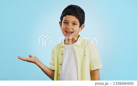 Kid, smile and happy for presentation in studio on blue background with mockup for product placement. Youth, boy and excited for opportunity, offer or deal on app, social media or digital marketing Kid, smile and happy for presentation in studio on blue background with mockup for product placement. Youth, boy and excited for opportunity, offer or deal on app, social media or digital marketing 138606400